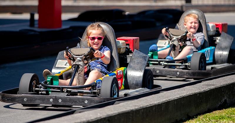 two kids in go karts on baby bristol track