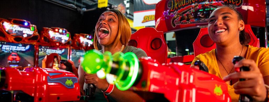 two women having fun in the arcade