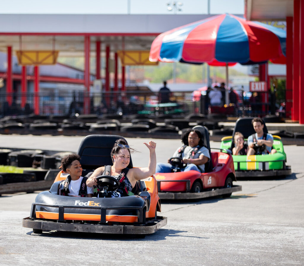 a woman giving thumbs up with a kid looking at her.