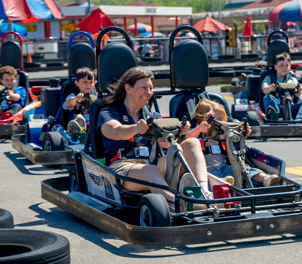 Woman and child riding go carts